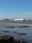 A ship making its way down the River Thames