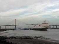 A ship unloading with the Dartford Bridge in the background