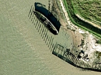 An old boat rotting away on the River Thames from GoogleEarth